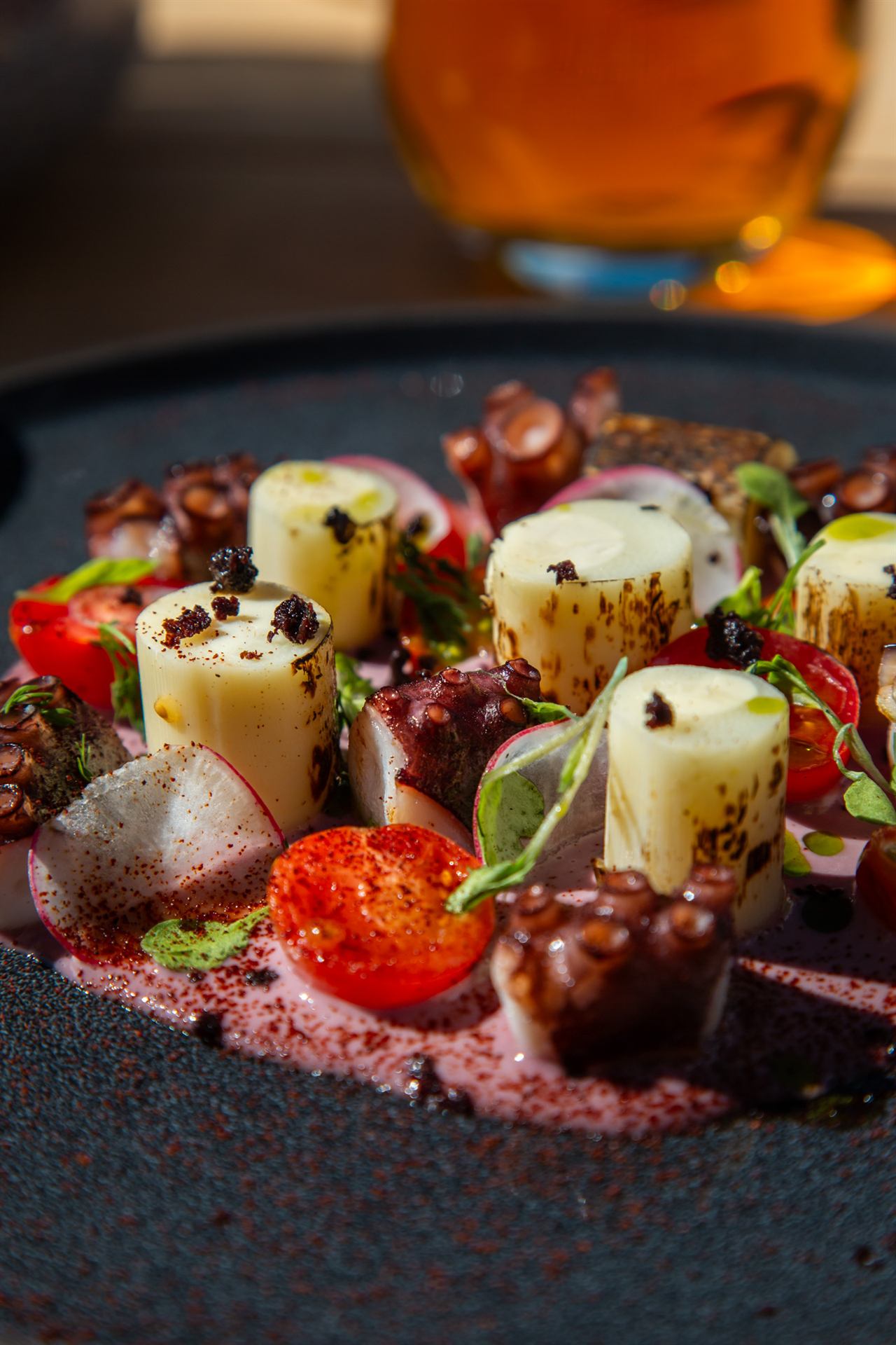 The plate, the glass, the waiter's hand serving